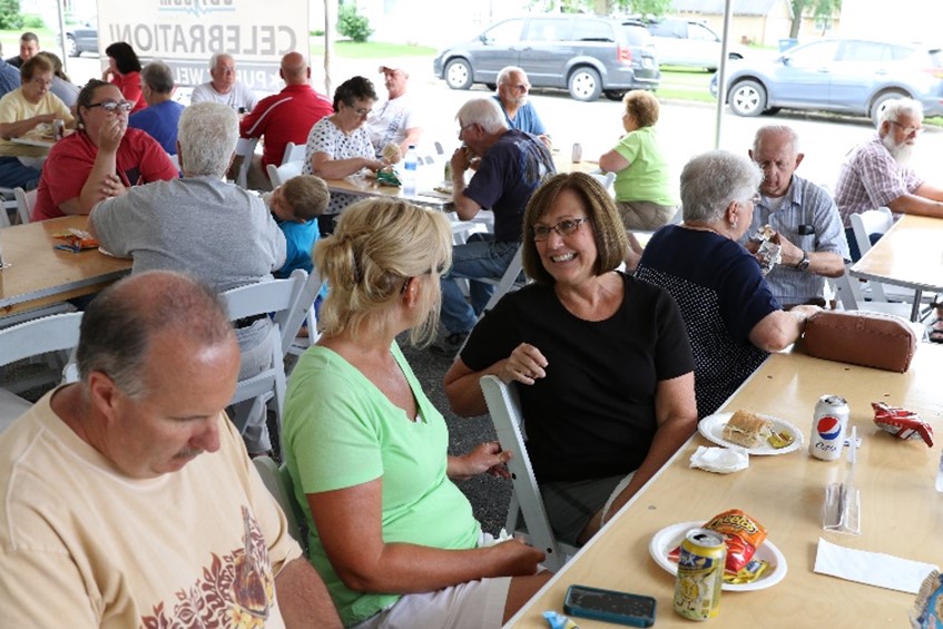 Group of people at an event, chatting and smiling