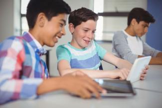 young boys using tablet